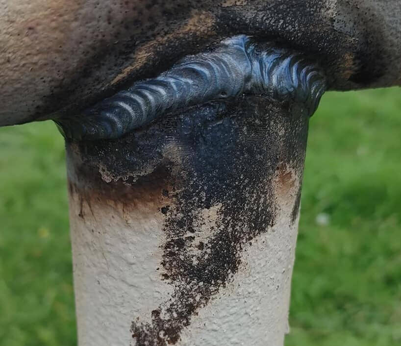 a black weld on a pipe fence