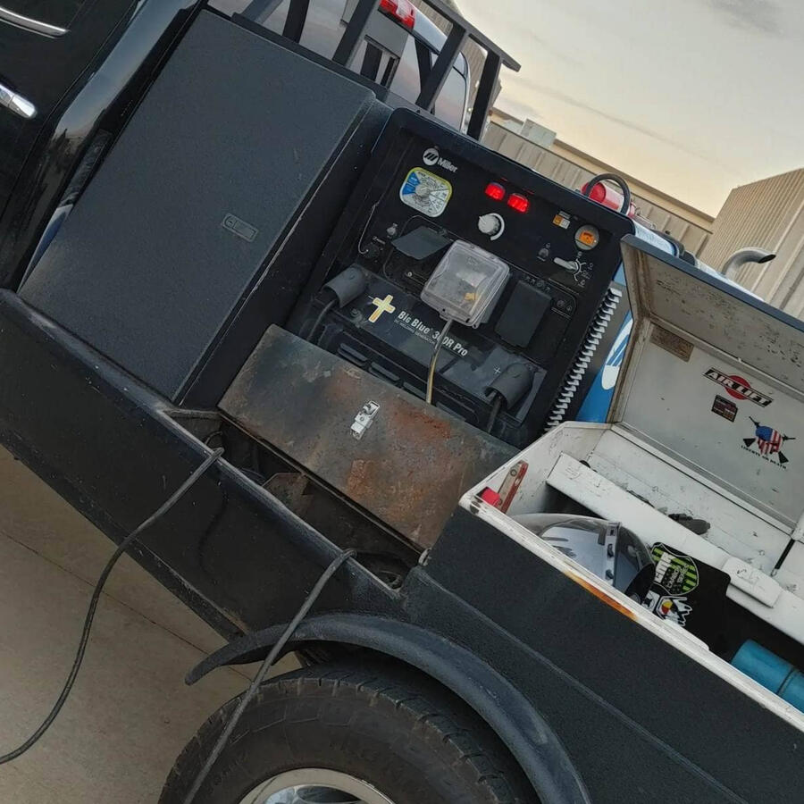 A black welding truck with tool box opened